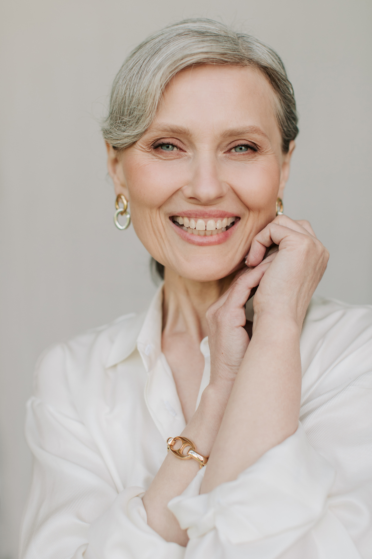 Smiling Senior Woman in Minimalist Jewelries