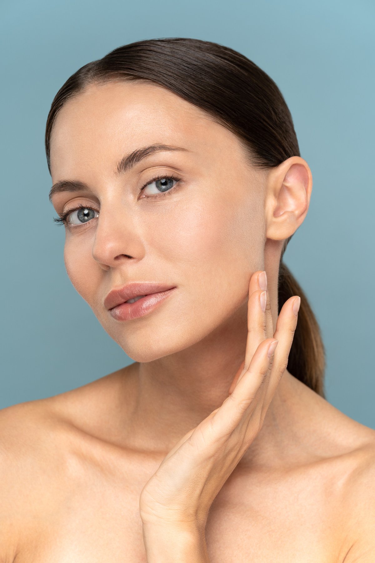 Woman Touching her Well-Groomed Skin on Face